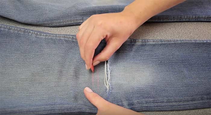 Mark the areas to rip or distress the jeans
