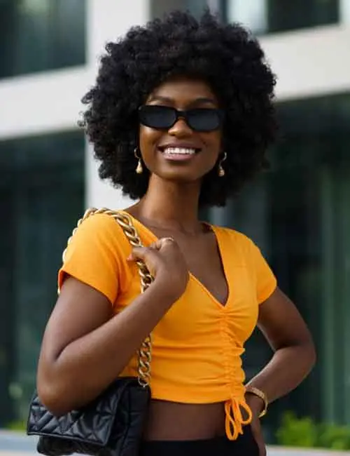 A woman wearing an orange crop top