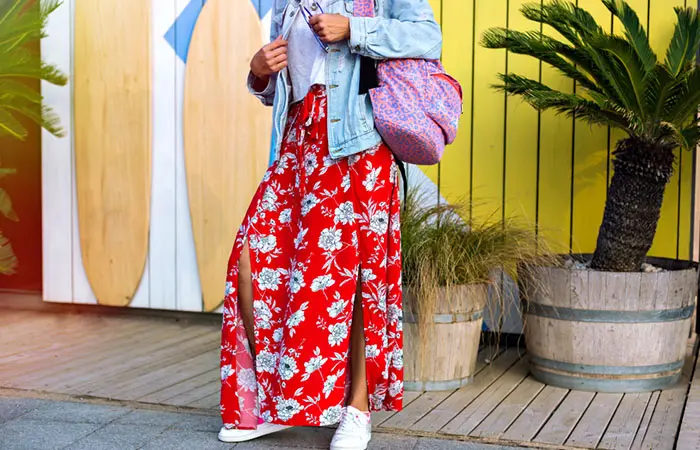 A curvy woman dressed in a floral maxi skirt