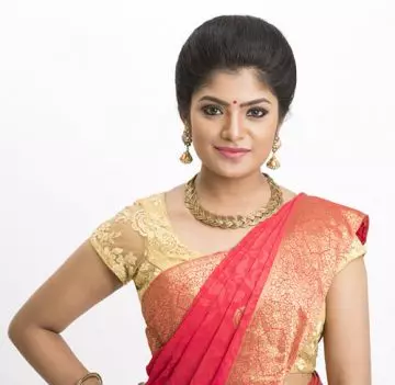 Puffed up bun hairstyle to complement your saree