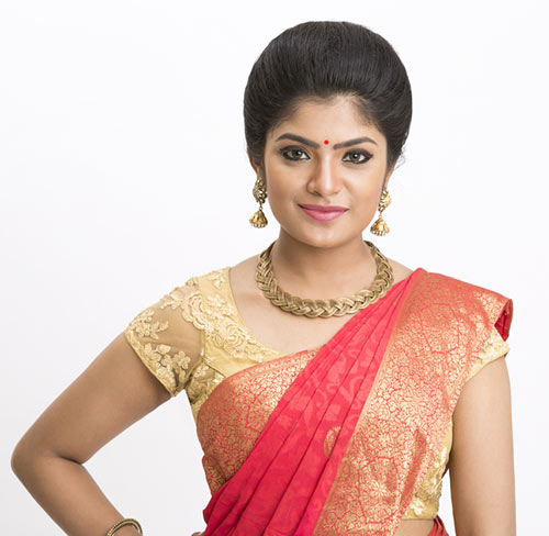 Puffed up bun hairstyle to complement your saree