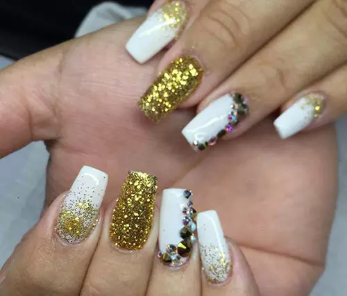 Gold and glittery acrylic nail design