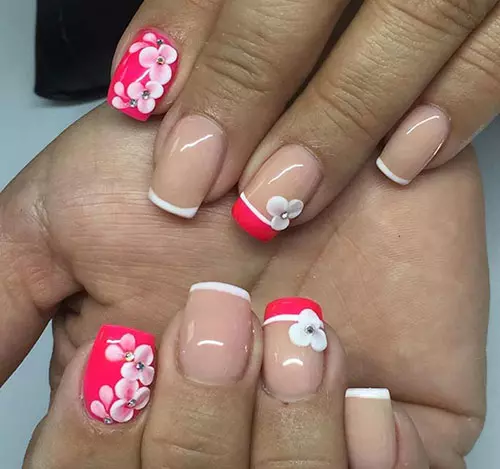 Red acrylic nail design with floral patterns
