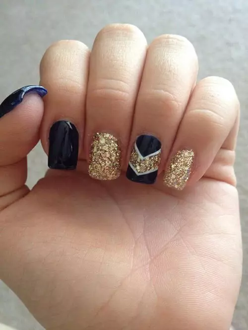 Navy blue and gold glitter acrylic nail design