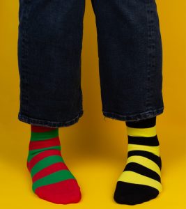 Woman wearing differently colored striped socks