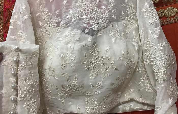 Pearl patch work on a white blouse with sweetheart neck design