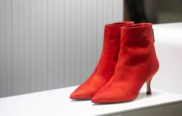 Red heeled boots from Stuart Weitzman, an expensive shoe brand
