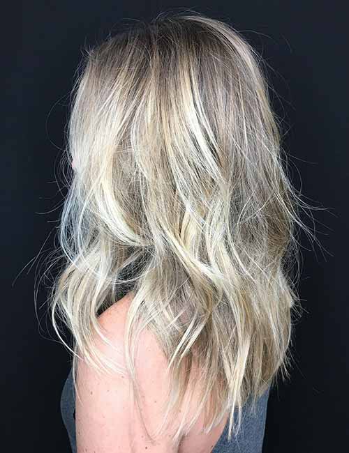 Dirty brown roots give way to light multi-toned ash brown streaked with ash blonde highlights for a heavily textured look