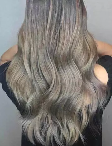 Ash blonde highlights placed as babylights create an illusion of volume and depth.