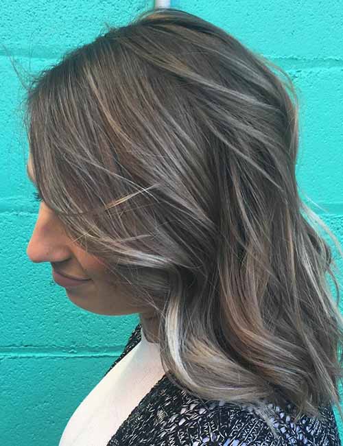 Smoky brown ash blonde highlights cover grays for a trendy and natural look