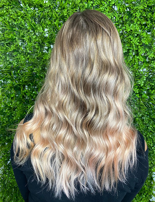 Back view of ashy blonde and caramel toned highlights