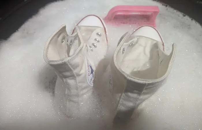 White Converse shoes in a bubble bath