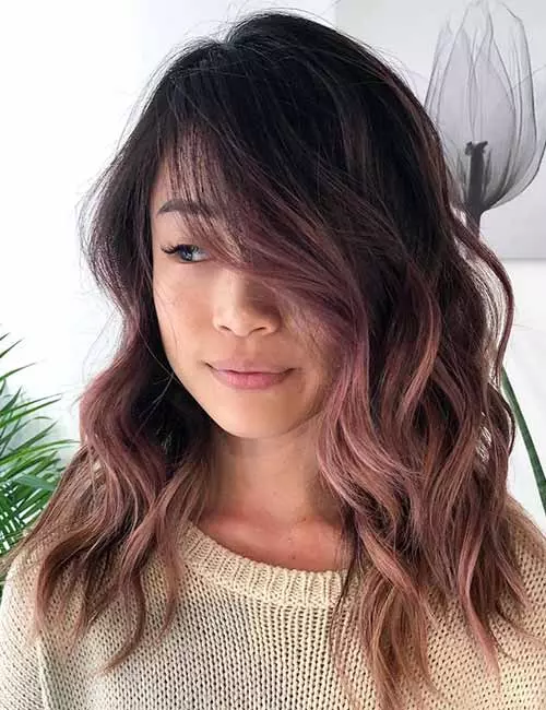 Rose gold ombre hair color on dark hair