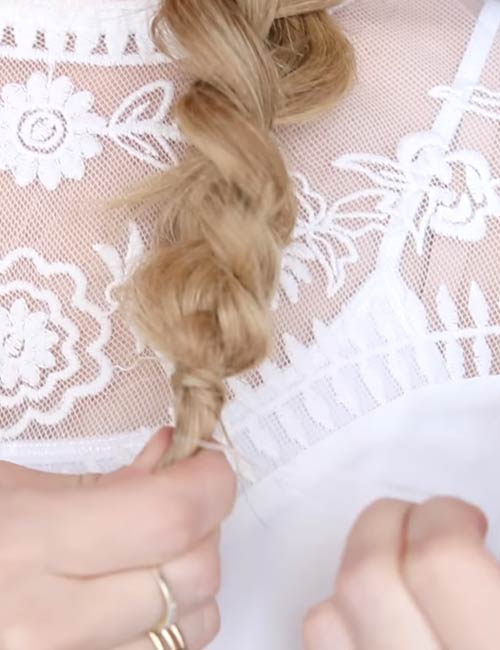 Tie the ends of the French braid with another hair elastic