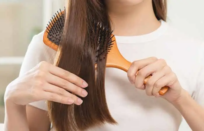 A woman combing her hair