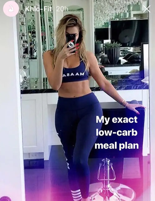 Khloe Kardashian taking a mirror selfie in her gym clothes
