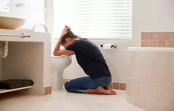 Woman throwing up in the bathroom