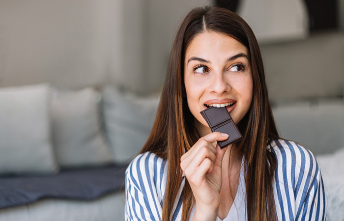 Woman having dark chocolate to induce a sneeze