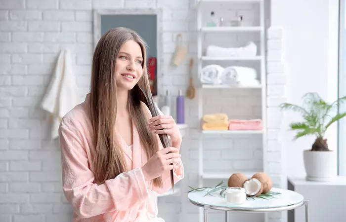 Woman applying coconut oil for lice treatment