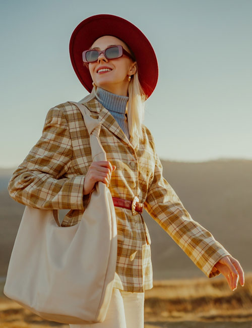 A stylish woman wearing a blazer with a belt and other accessories