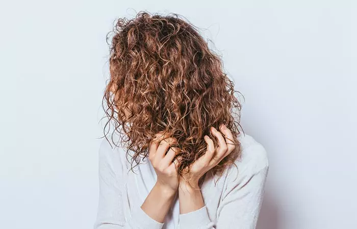 Scrunch your curly hair while air-drying to enhance its structure