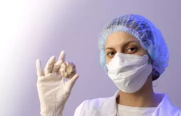 Doctor holding garlic in hand