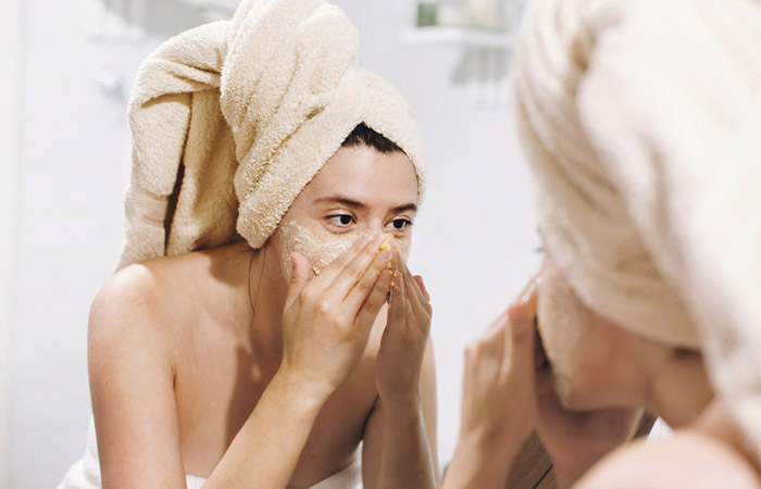 Woman exfoliating her skin with proper steps