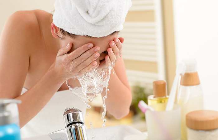 Woman cleaning her face with water for clean-up
