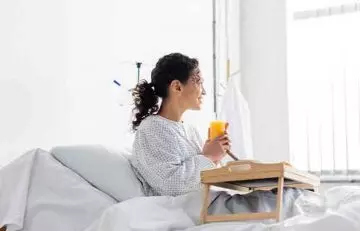 Woman drinking fruit juice before surgery