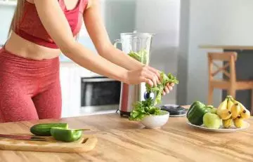 Woman making a nutritious smoothie at home 