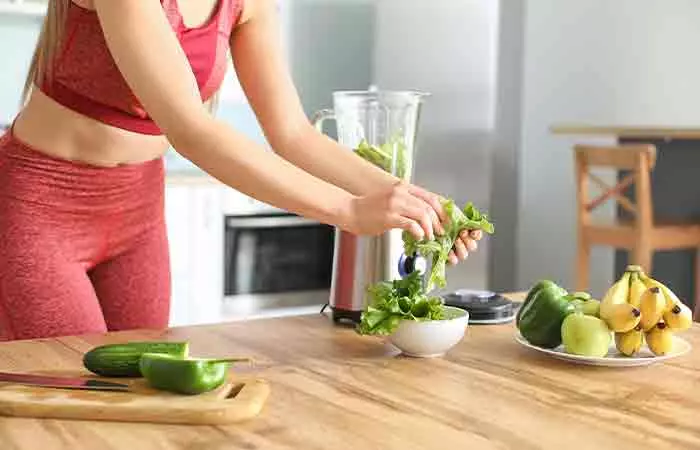 Woman making a nutritious smoothie at home 