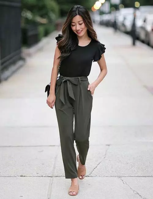 A ruffled top with high waisted olive green pants