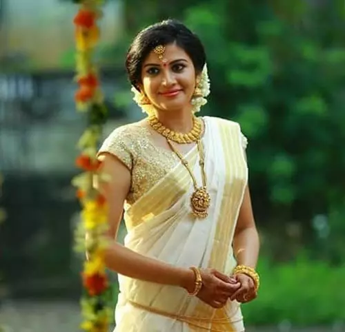 Pair Kerala saree with a golden blouse