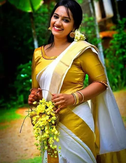 Pair Kerala saree with gold brocade blouse