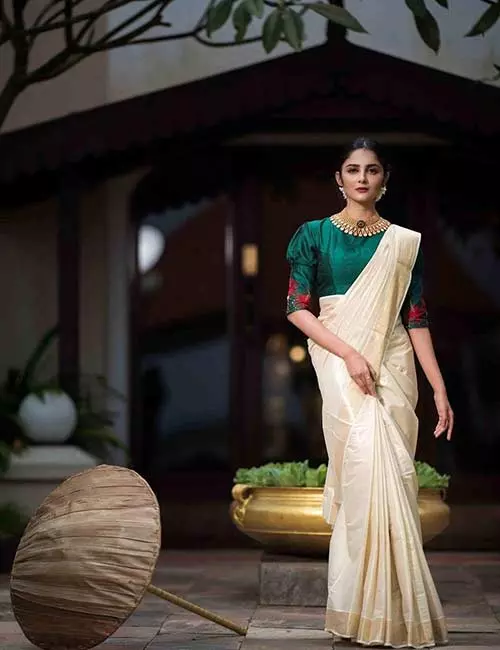Pair Kerala saree with green raw silk blouse