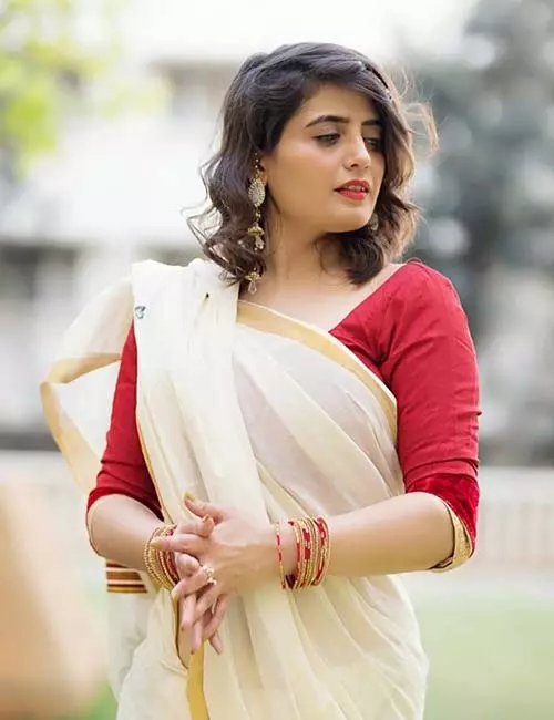 Pair Kerala saree with plain red blouse