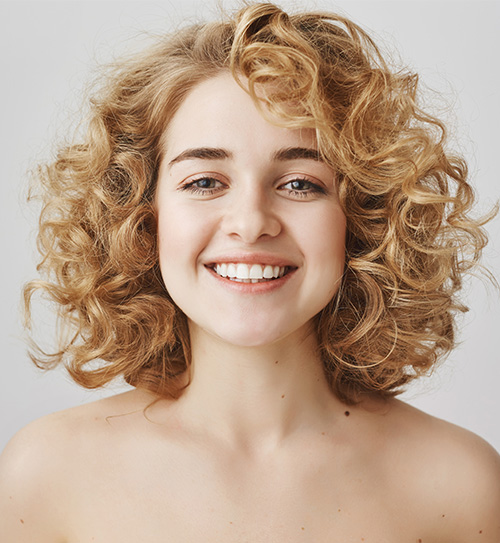 Messy short curly hairstyle with bangs