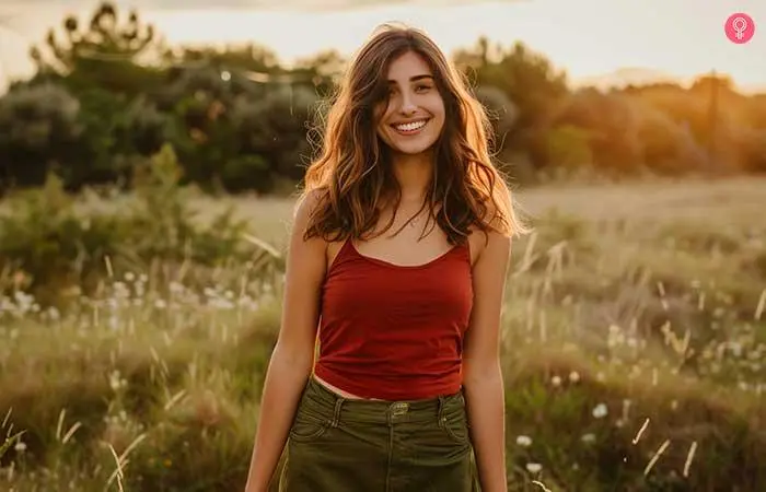 Olive green pants with a red cold shoulder top