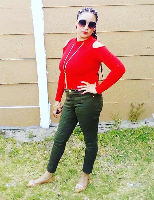 Olive green pants with a red cold shoulder top