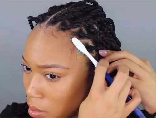 Smoothen down baby hair with brush