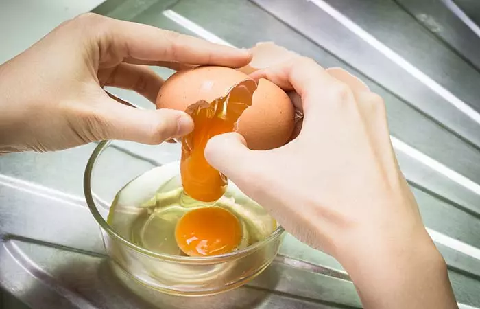 Cracking Eggs On The Rim Of A Bowl 