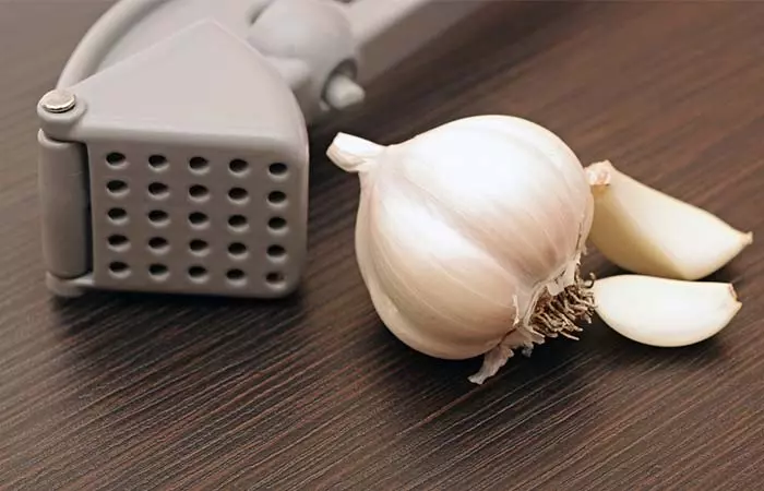 Peeling The Garlic Before Putting It Into The Press