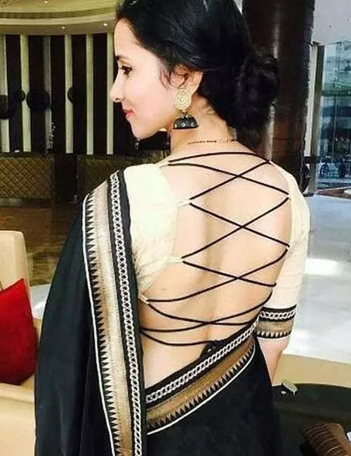 Plain black saree with a backless designer blouse