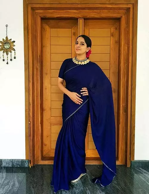 Plain blue saree with a boat neck designer blouse