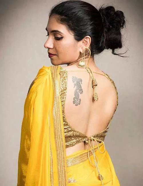 Plain yellow georgette saree with a brocade designer blouse