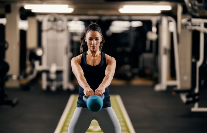 A woman performing kettlebell swings
