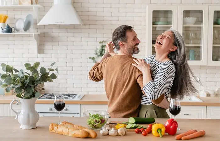 A happy couple dancing in the kitchen