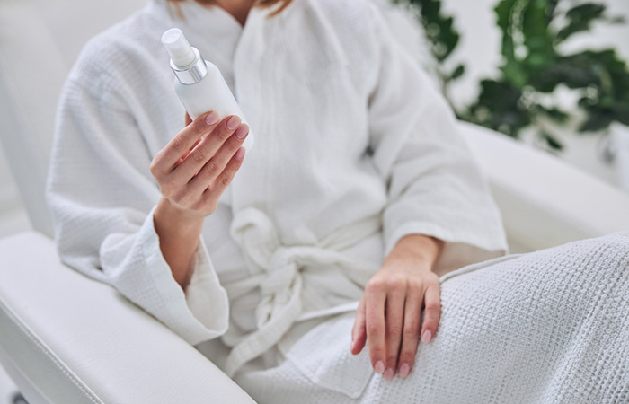 Close up of a woman reading the instructions of the cream.