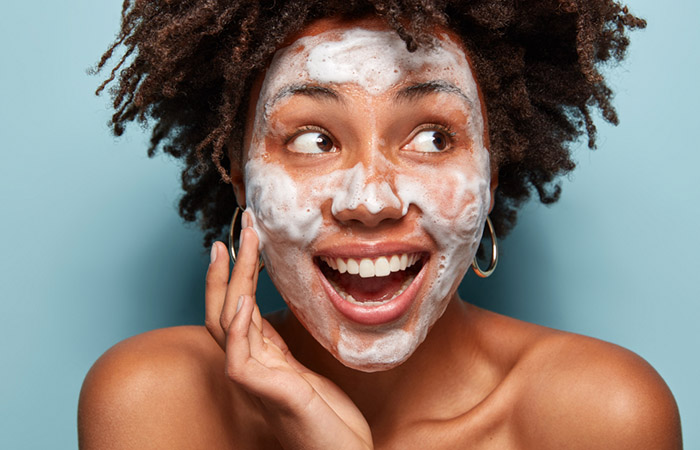 Woman using african black soap of her face for healthy skin