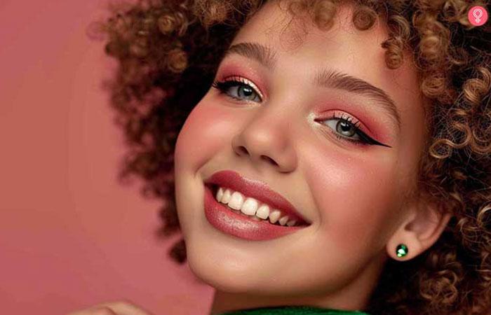 Model with dramatic pink and green eye makeup on